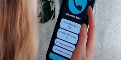 Blind or visually impaired individual holding a smart phone displaying the Aira app functions on the screen.